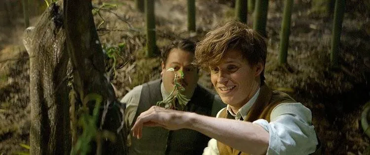 Eddie Redmayne y Dan Fogler con un personaje animado de la película